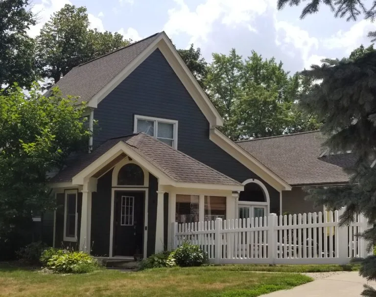 Blue house with white trim painted by TM Professional Painting